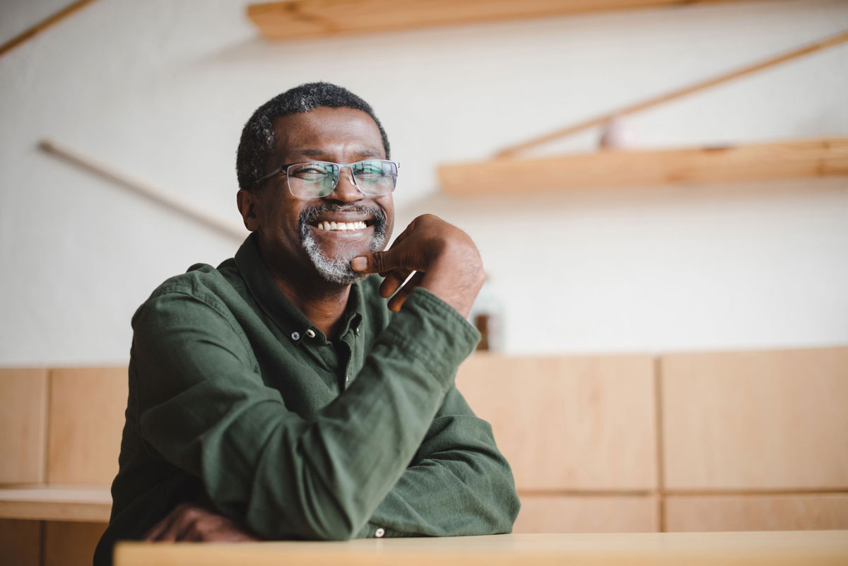 Man sitting at table smiling