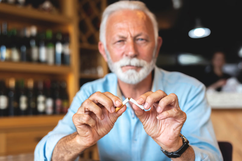 man breaking cigarette